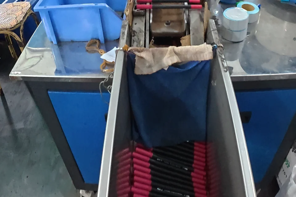 Marker barrels and caps on the assembly conveyor.