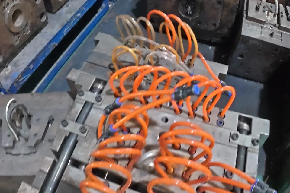A close view of component moulds and connected fittings.